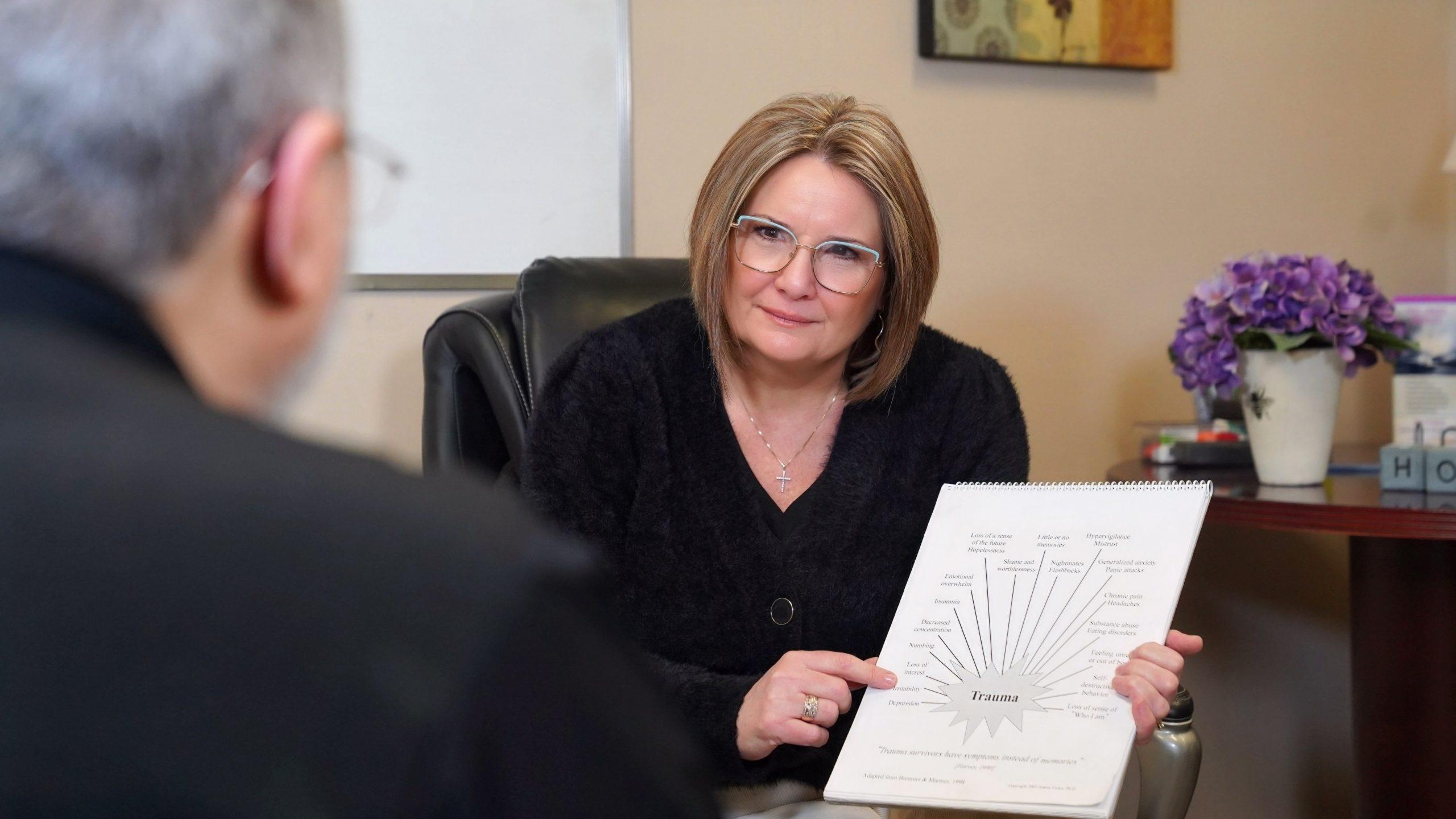 Cornerstone therapist Evelyn speaking with a client with compassionate look on her face