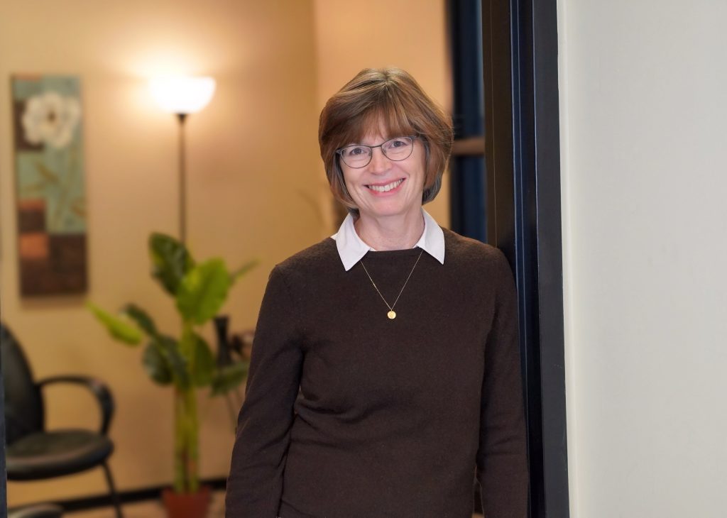 Ruth standing in a doorway smiling