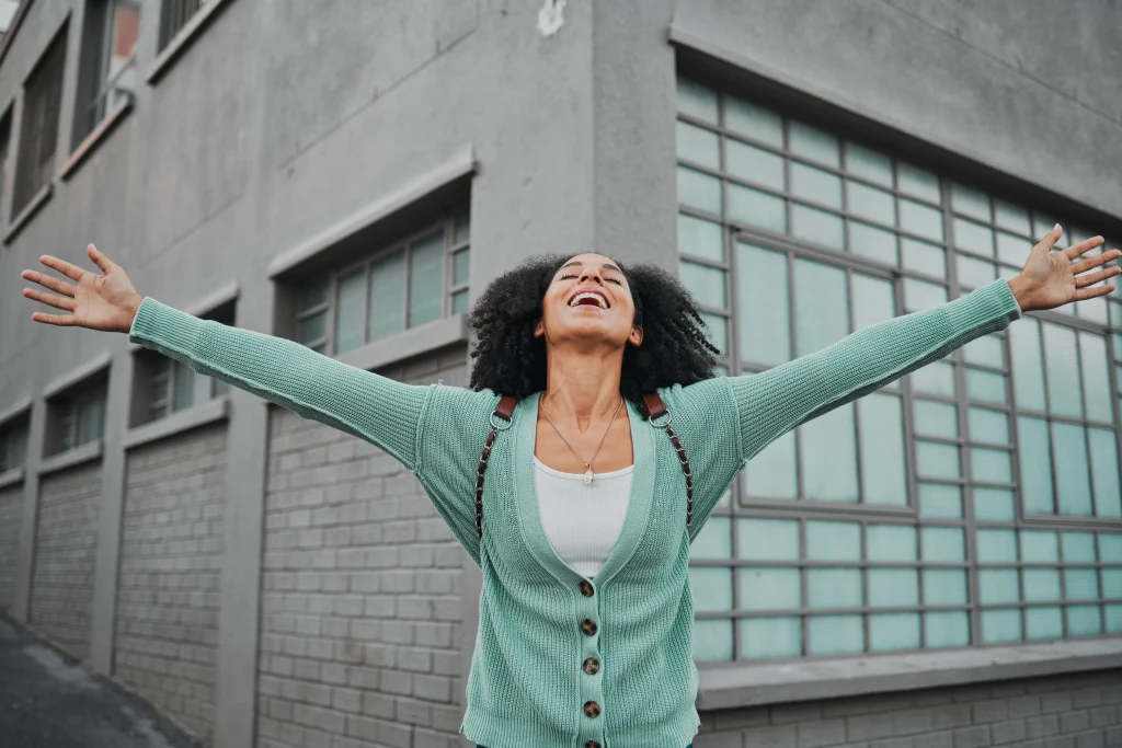 Woman outside with arms wide open