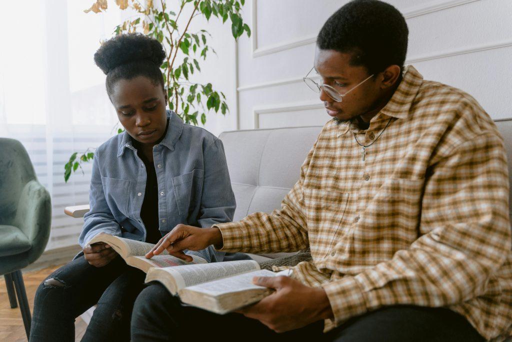 Woman and man looking at their Bibles