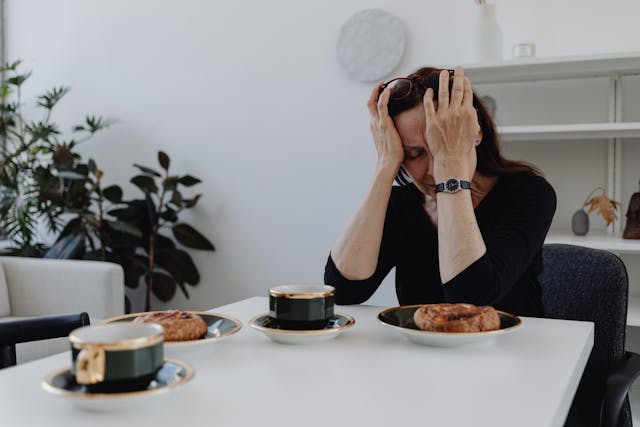 Woman experiencing grief at the dinner table