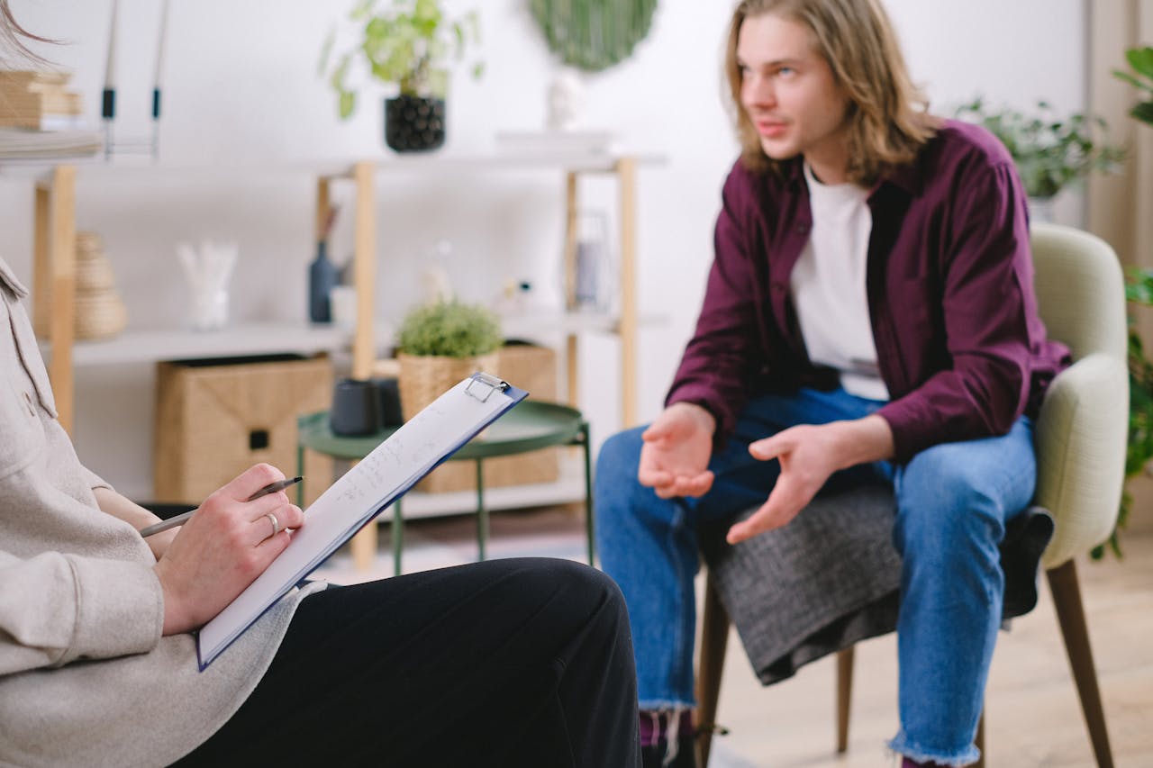 Therapist with young man with long blonde hair