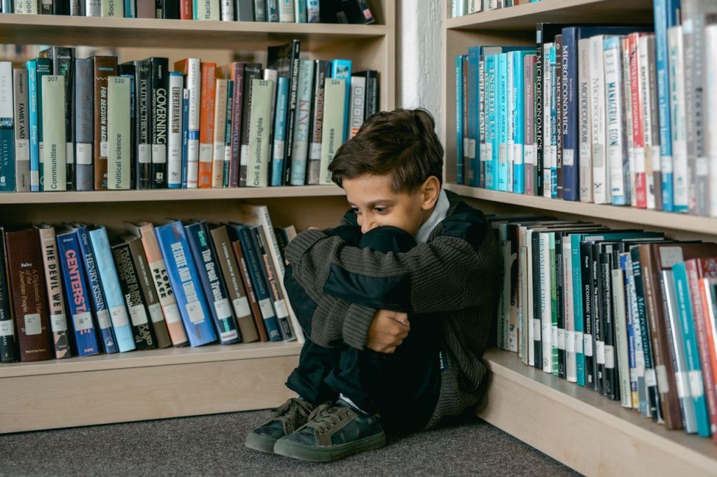 Child sitting on a floor in a school library