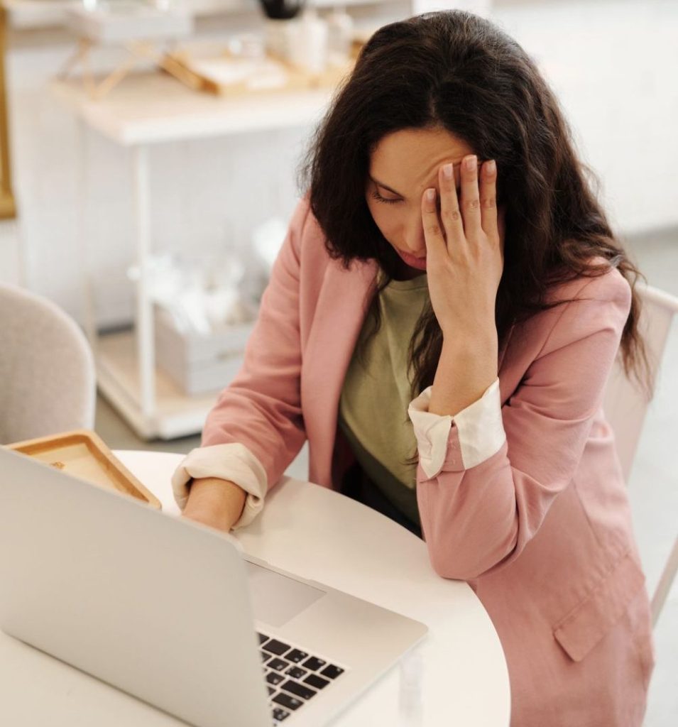 Woman at a desk stressed