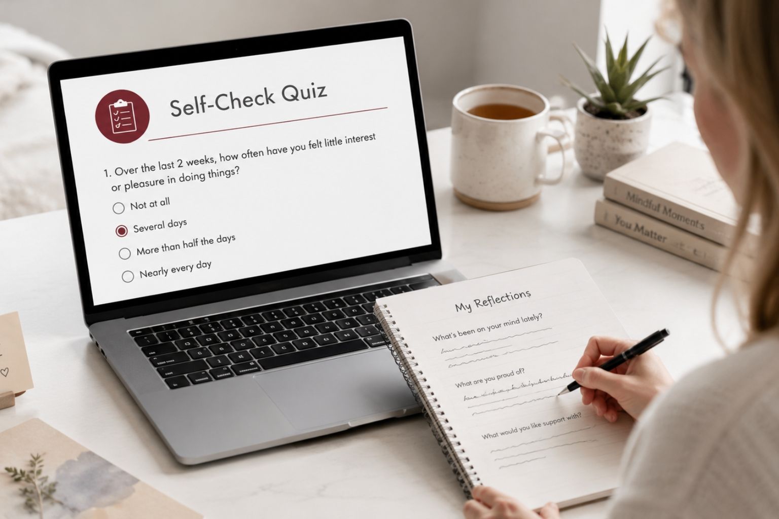 Person completing a self-check mental health quiz on a laptop while writing reflections in a notebook at a calm workspace.