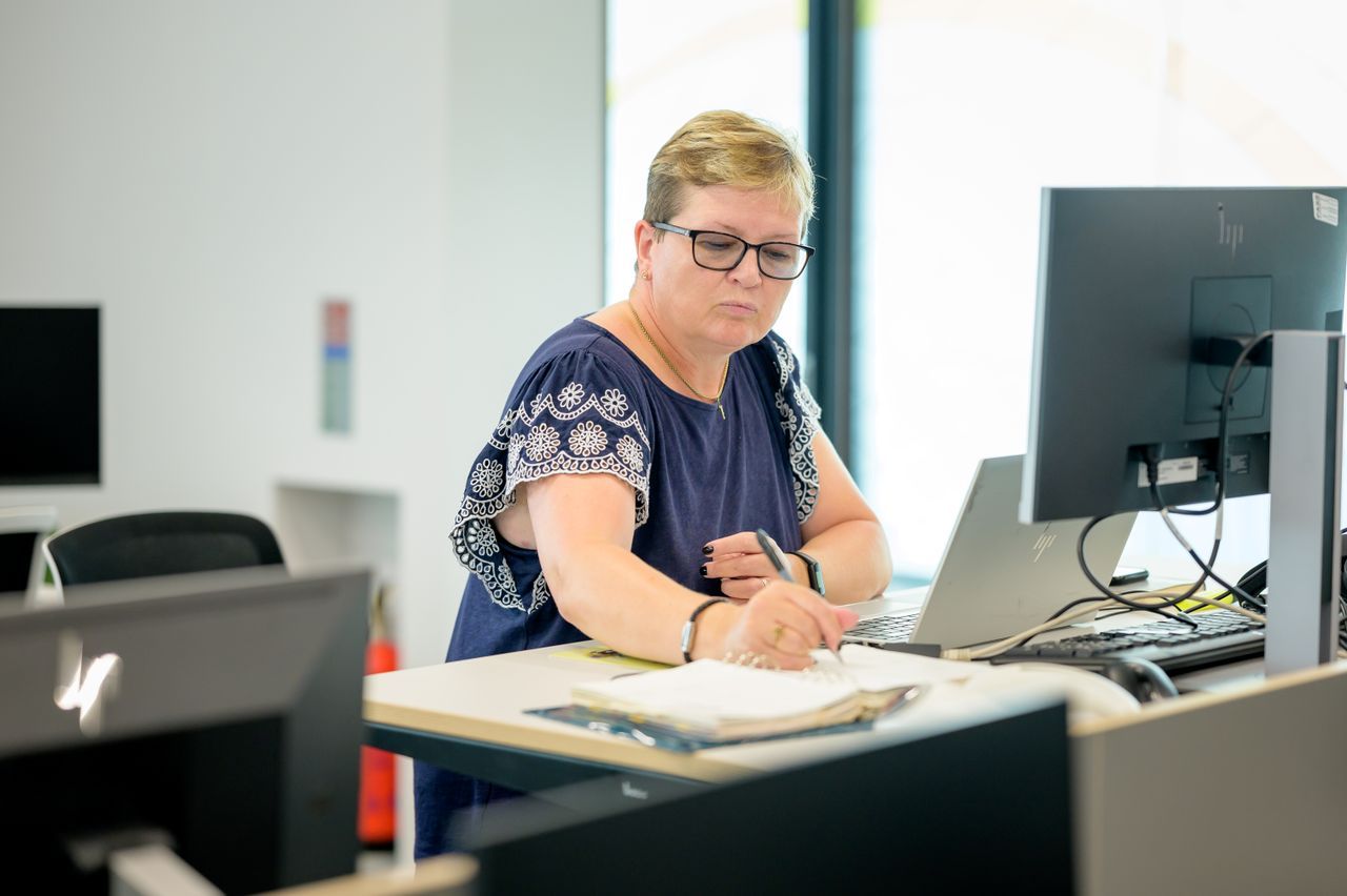 Middle aged woman working at a desk in the office
