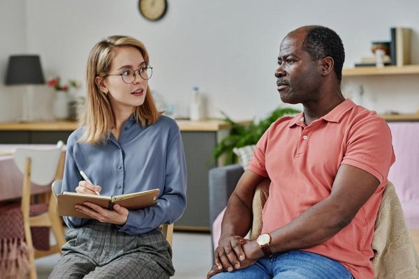 A white female therapist with a black male client