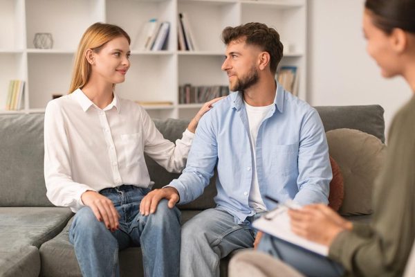 Couple counselling session with the couple touching and looking at each other